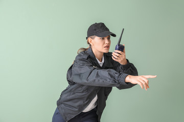 Female police officer on color background
