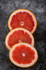 Sliced grapefruit circles on a marble