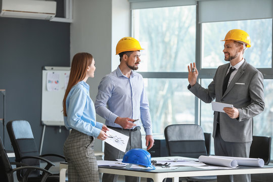 Group Of Engineers Working In Office