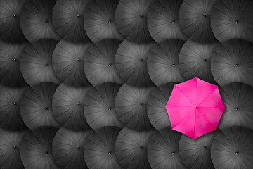 Stand out pink umbrella on pattern arrangement. Concept of leadership, victory. Nobody