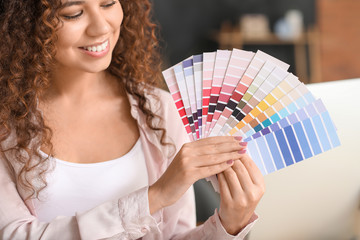 African-American designer with color palettes in office