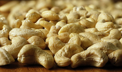 Raw cashew nuts on a textured wooden background, countertops, close-up