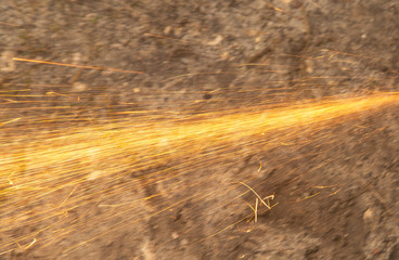 Sparks from sawing metal at a construction site