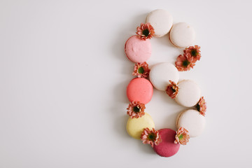 Figure eight from colorful french macaroons. March 8 concept, Women's Day. copy space
