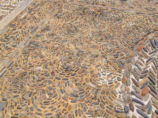 Cobblestone pattern with circular ornament closeup