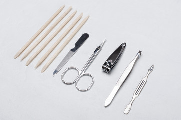 Closeup of special manicure tools on the white desktop