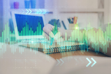 Financial graph displayed on woman's hand taking notes background. Concept of research. Double exposure