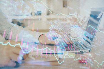 Multi exposure of stock market graph with man working on laptop on background. Concept of financial analysis.