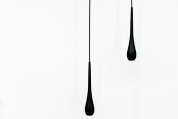 two black pendant lamp over white wall