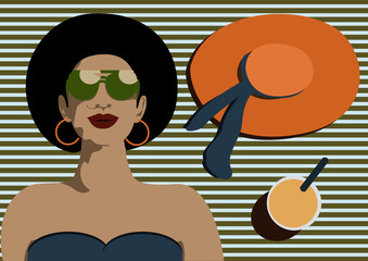 Aerial view of woman with dark hair relaxing on towel at beach  with modern green sunglasses ,big orange hat, cup of orange juice against blue striped background, vacation traveling concept