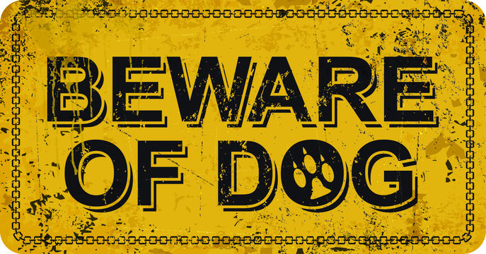 Beware of dog on yellow vintage rusty metal sign