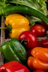 Hot chili peppers in a rustic wooden tray. top view