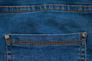 Pocket on denim trousers. Blue fabric with brown stitching. Photo for design