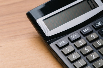 Modern calculator, Business and Finance accounting concept on wooden table
