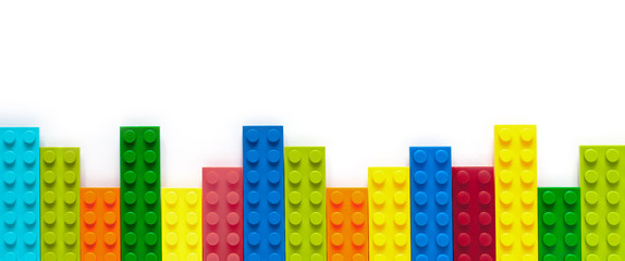 Colored toy bricks on white background
