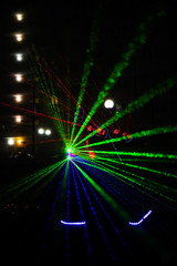 Fototapeta na wymiar multi-colored laser beams. man laserboy. laser lines in the dark