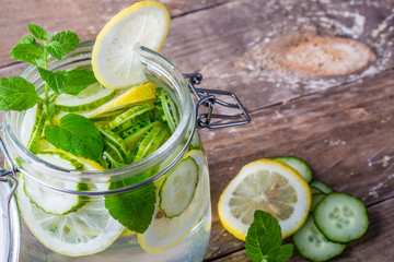 Lemon and cucumber detox water in glass jar