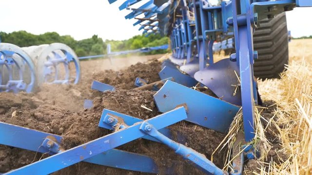  Plow plows earth in field, steady shot, close up, slow motion, agriculture industry team