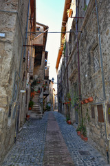 Fototapeta na wymiar Anagni, Italy, A narrow street between the old stone houses of a medieval village.