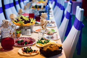 festive table in the restaurant with plates, glasses and Cutlery on a white tablecloth