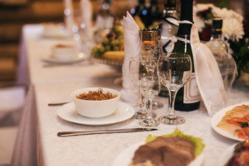 glasses and plates with snacks on the festive table