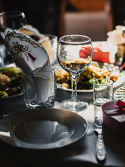 festive table in the restaurant with plates, glasses and Cutlery on a white tablecloth