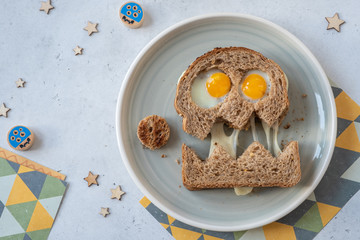 Fun Halloween monster sandwich with bread, eggs and cheese on plate