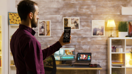 Using a smart light application to turn on the light bulbs in the house