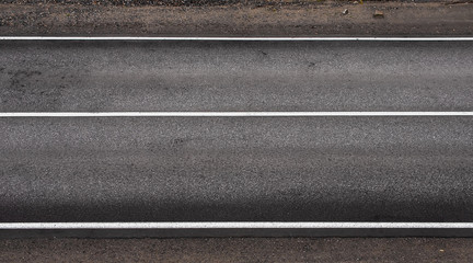 Asphalt highway texture with three white stripes