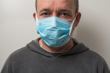 Portrait of man with medical mask to protect against the corona virus