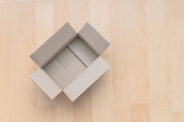 Empty open rectangular cardboard box on wood background. Shopping online object background.