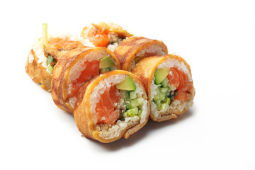 Sushi with salmon, cucumber and avocado wrapped in a tamago nigiri omelette. Sushi on a white background