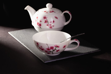 Cup of Tea and Teapot on the slate plate on the table