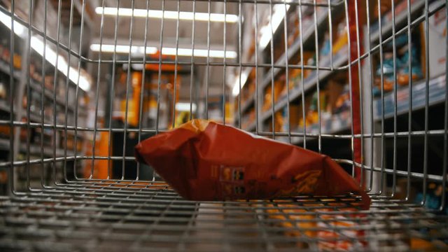 Shopping trolley - buying crisps in the grocery department