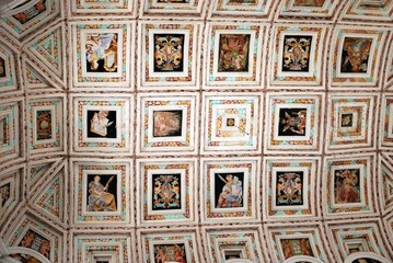 Ceiling detail showing multiple individual scenes inside the Hospital de Santiago, Ubeda, Spain.
