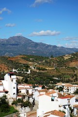 Fototapeta na wymiar View over town rooftops towards the mountains, Guaro, Spain.
