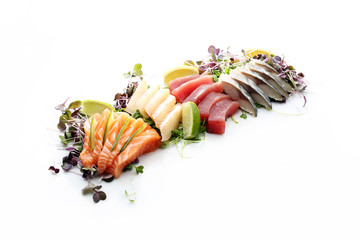   Sashimi, raw fish and seafood. Traditional Japanese dish. Composition on a white background.