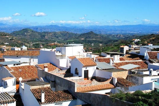 View over town rooftops towards the mountains, Guaro, Spain. - Powered by Adobe