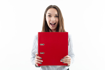 Portrait of a girl in an office dress code with a red folder on a white background. Emotional girl