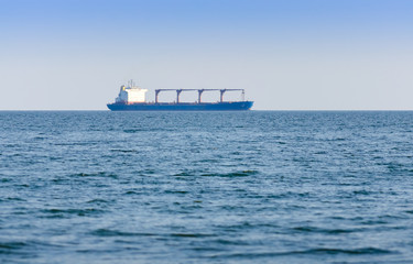 Loaded cargo ship sailing to destination port. - 325986347