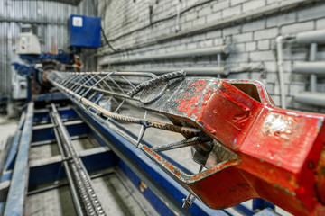 Machine for the manufacture of reinforced concrete carcass piles. Automatic spot welding of metal rods.