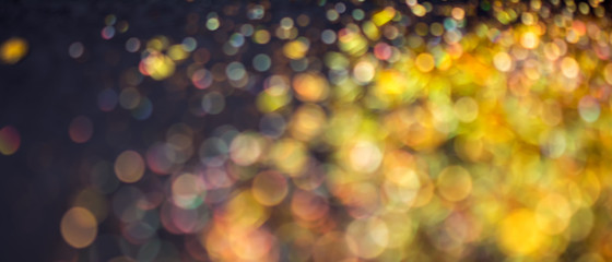 Abstract golden and black background with bokeh effect
