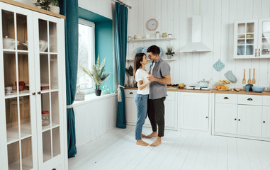 Young couple dancing in the kitchen