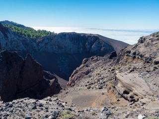 View to crater of volcano El Duraznero along the path Ruta de los Volcanes, beautiful hiking trail at La Palma island, Canary Islands, Spain, Blue sky background