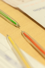 colored pens on wooden table