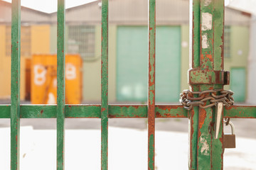green gate with closed lock