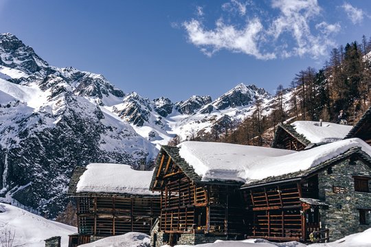 The traditional architecture of the Walser villages in the valleys of Monte Rosa, during a fantastic winter day, near the town of Alagna, Italy - February 2020.