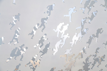 silhouettes of people running on metal background