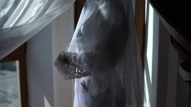 bride with veil in a bathrobe