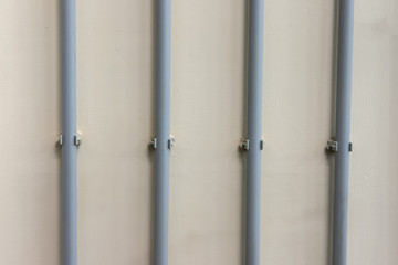 Wires on the wall in the corrugation and smooth lines